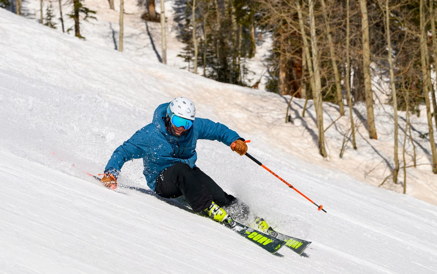 Tomas Mical carving between aspen trees on a sunny day