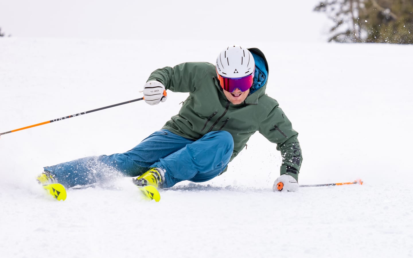 Tomas Mical in a green jacket on a groomed run