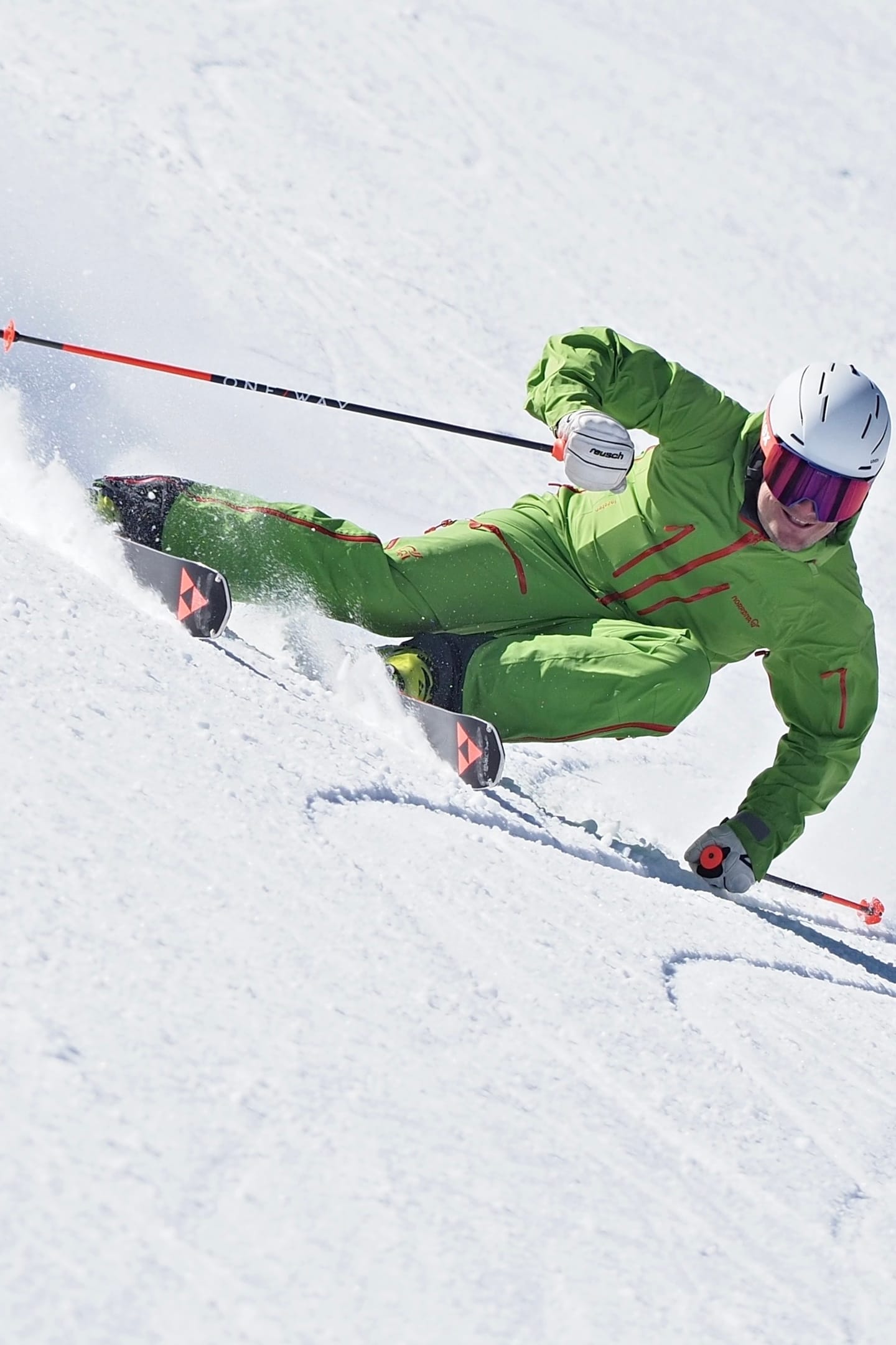 Tomas Mical in a green race suit in a carved turn